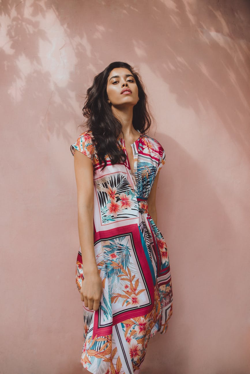 young woman in colourful dress on street